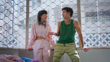 happy teenagers laughing together in laundry room. cheerful girl guy washing