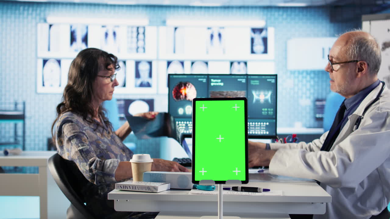 Vertical Video Senior medic consulting ill woman in cabinet with isolated mockup screen