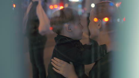 Tired-boy-giving-hug-to-mother-at-bus-stop