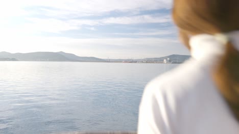 dolly in shot, of a girl gazing upon the sea