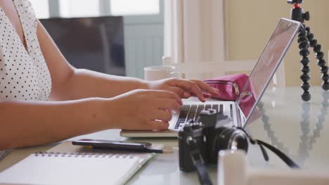 caucasian vlogger woman doing  video montage at home