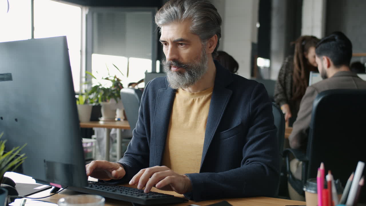 Man Working on Computer in Modern Office