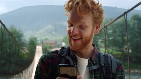 hiker typing message smartphone. tourist scroll social media in mountains nature