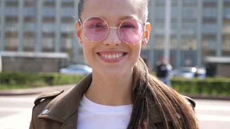 young woman in pink sunglasses