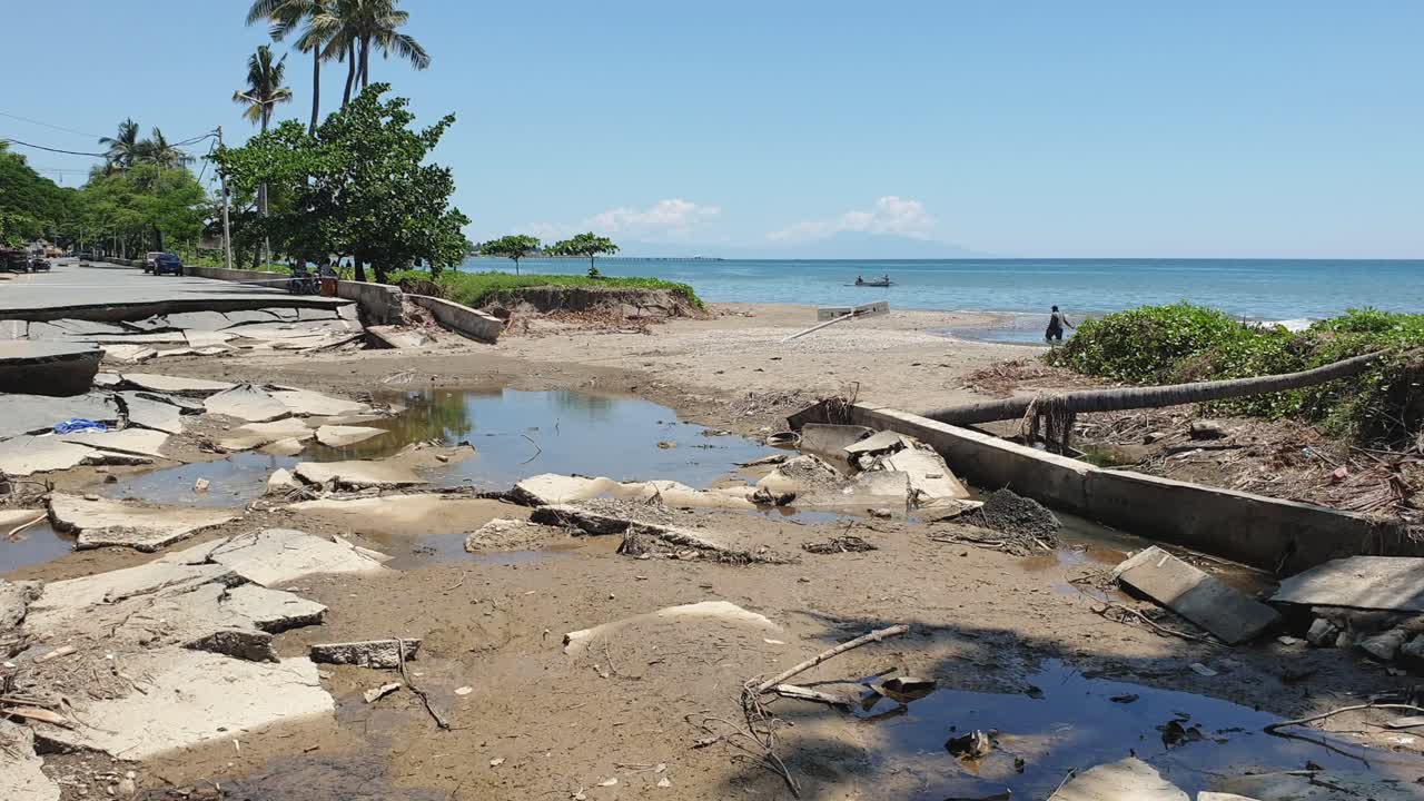 A main road damaged and washed away into the ocean by devastating weather conditions and flash flood in capital Dili, Timor Leste, Southeast Asia