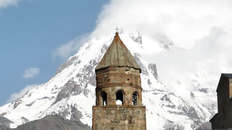 kazbek mountain and gergeti trinity church in georgia - aerial shot