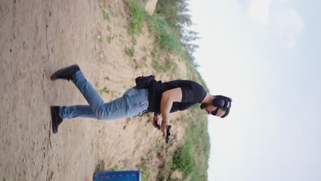 vertical view of male shooter take position, insert magazine and fire bullets