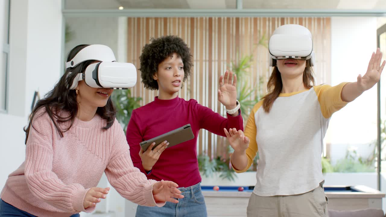Facilitator tapping tablet guiding diverse female team adjusting VR headsets and reaching in lounge