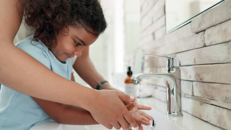 mom helping child, washing hands in bathroom