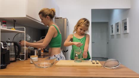 mother and daughter cooking together in the kitchen