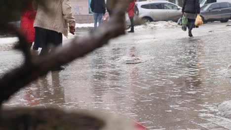 people walk on road puddle on background