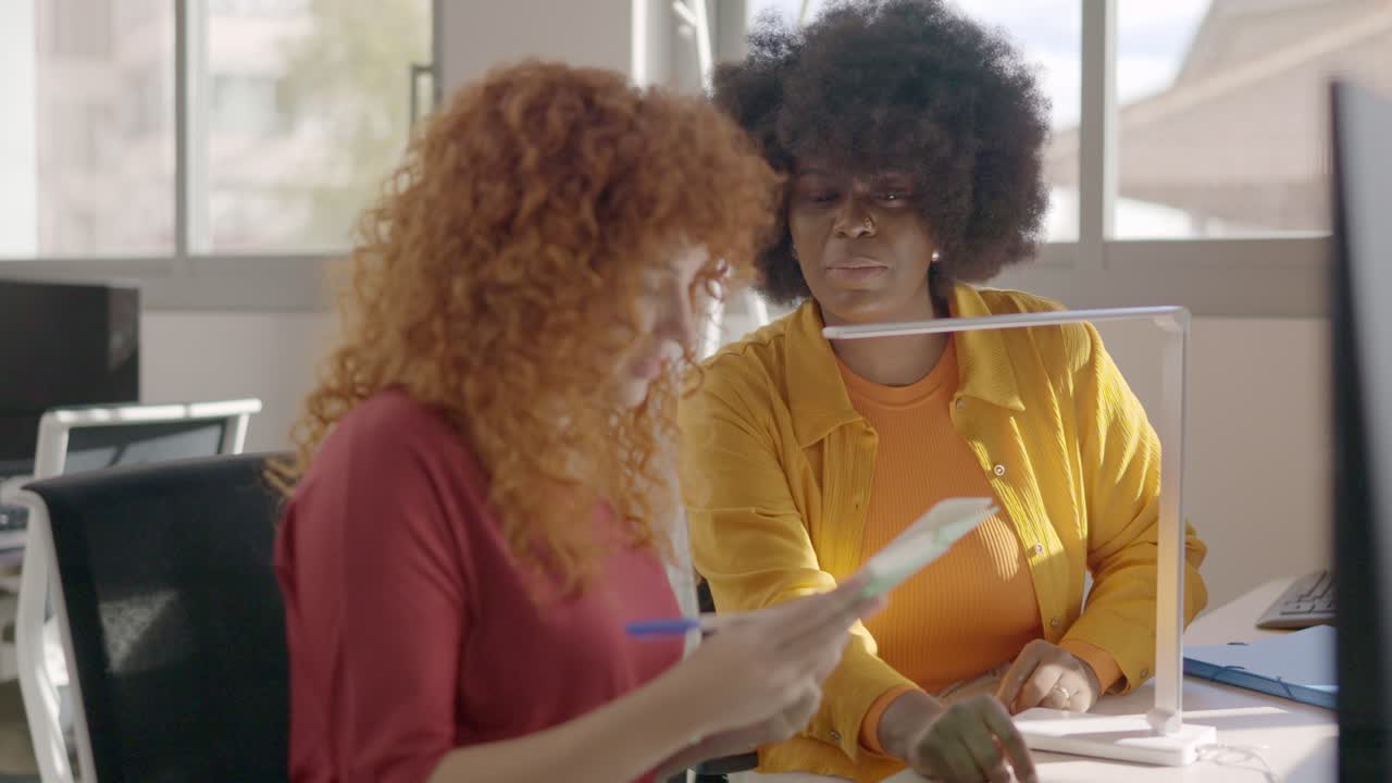 Multi-ethnic coworking colleagues talking in the office