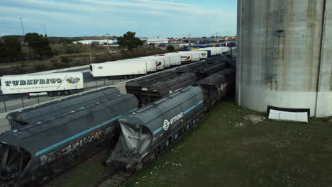 industrial rail yard with tank cars and trucks
