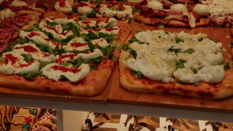 delicious pizzas with mouthwatering toppings in pizzeria. closeup