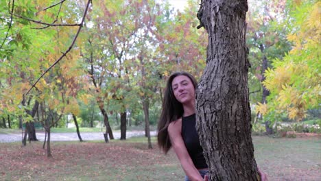 Beautiful-girl-playing-around-a-tree