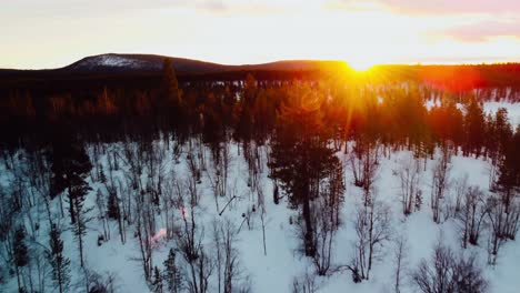 Sunset-in-the-Arctic-Circle-with-a-sports-car-driving-on-a-frozen-lake