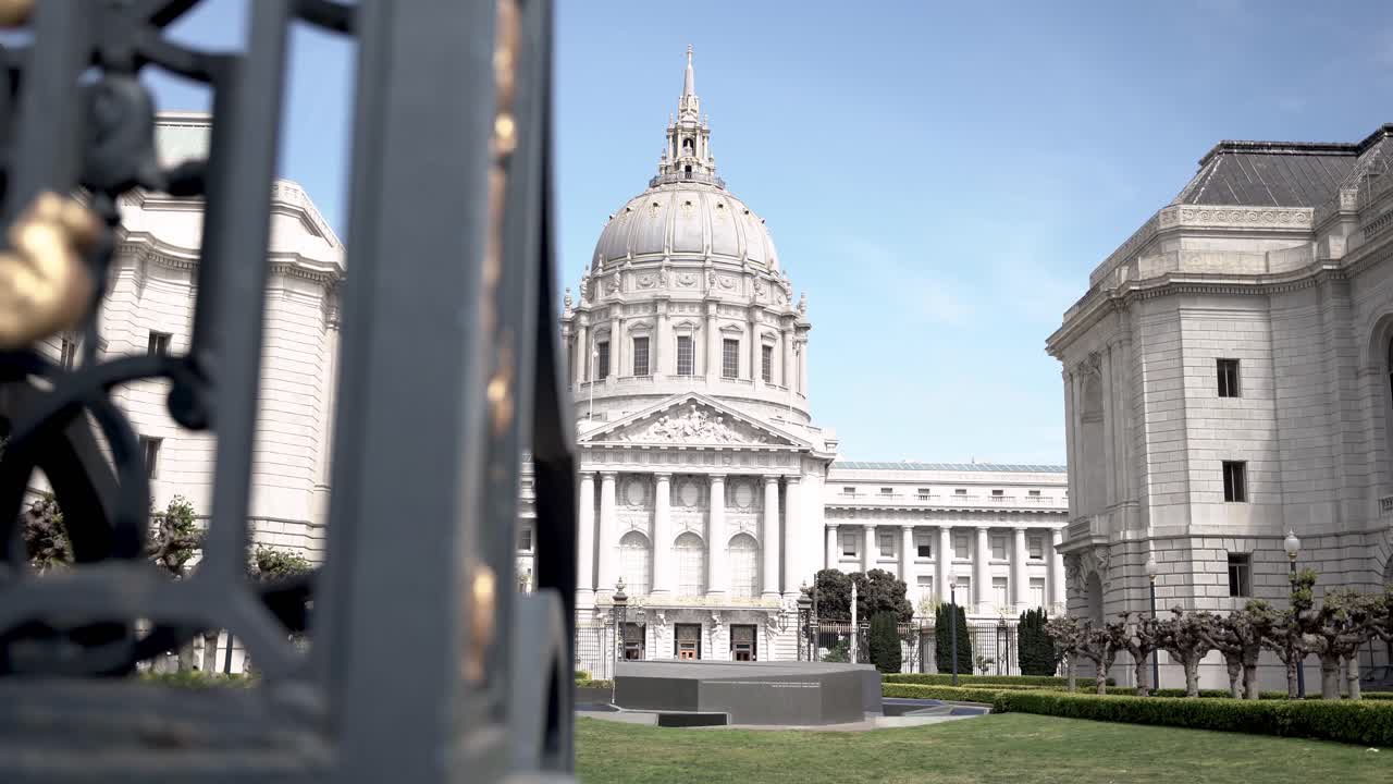 Closeup of a metal gate and the appearance of the Civic Center