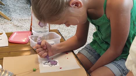 child creating art with icing and pastry bags