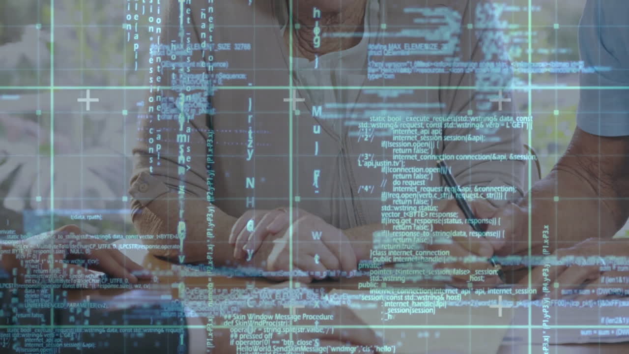 People working at desk with programming code and data processing animation overlay
