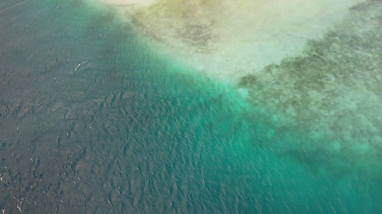 Punta madrisky, los roques with vibrant blue and turquoise waters, aerial view