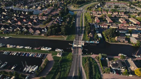 A-suburban-area-with-houses,-roads,-canal,-and-marina-during-daytime,-vibrant-community,-aerial-view