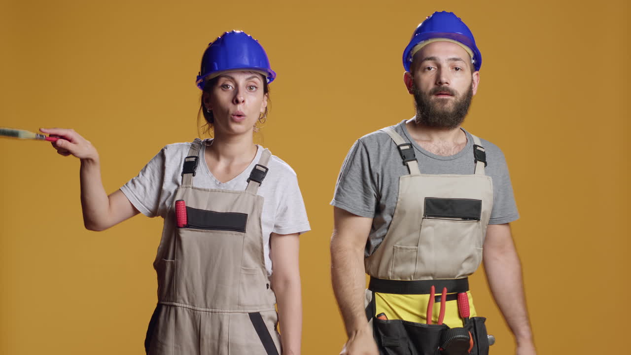 Team of builders with refurbishment skills painting walls