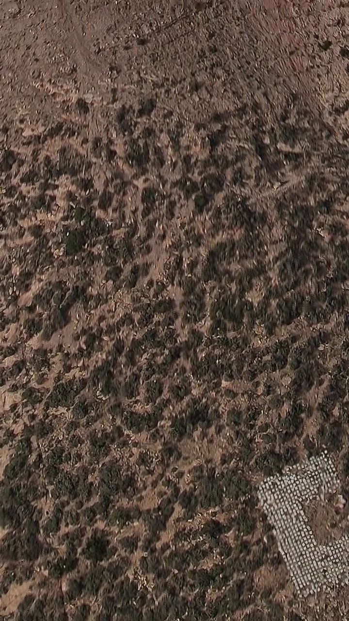Aerial view of a rocky landscape in Morocco with vegetation and earth