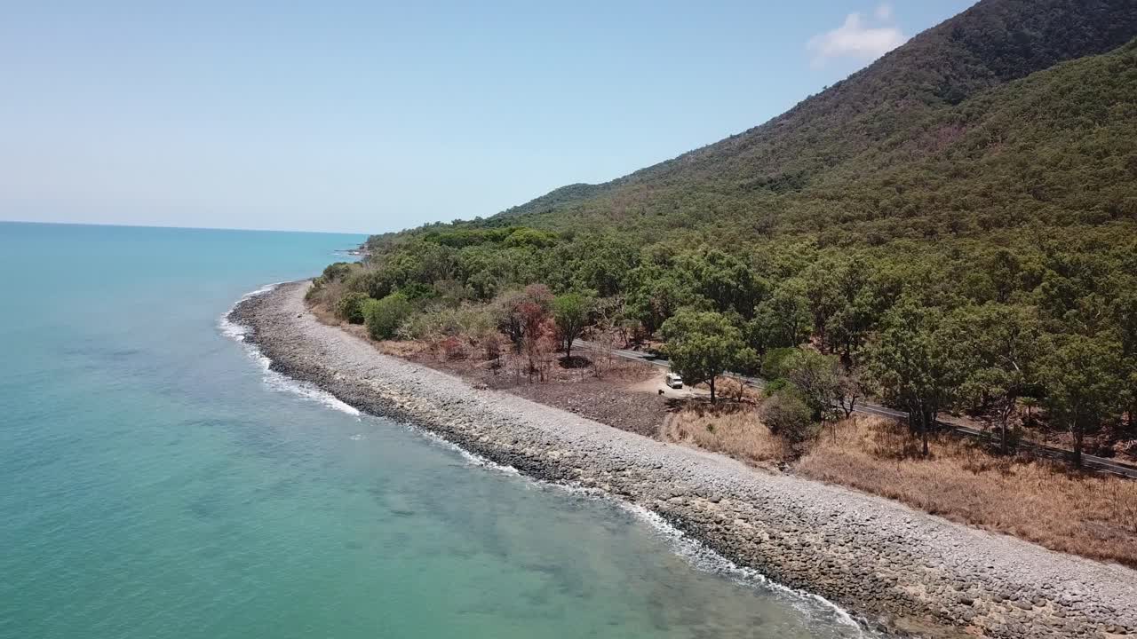 Drone aerial pan up and side to reveal tropical mountain
