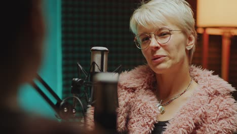 beautiful woman answering questions of podcast host during interview