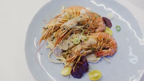 Fresh-shrimps-with-pasta-and-vegetables-served-on-a-white-plate