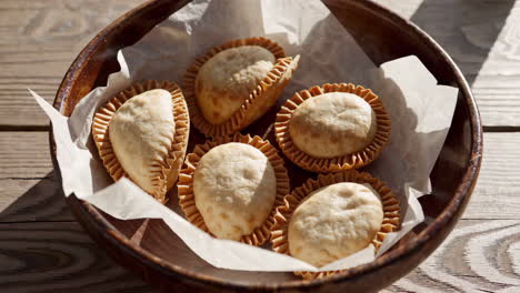 empanadas in a wooden bowl