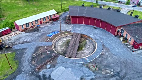 an aerial view of an abandoned narrow gauge coal rail road round house and turntable starting to be restored