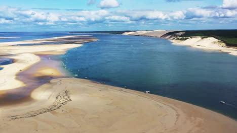 Banc-d'Arguin-at-Arcachon-Bay-France-with-boats-anchored-along-the-coast,-Aerial-dolly-left-view