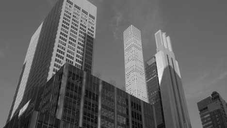 Low-angle-black-and-whit-shot-of-Vintage-stylized-photo-of-Manhattan-skyscrapers-at-sunset,-looking-up-perspective,-New-York-City,-USA