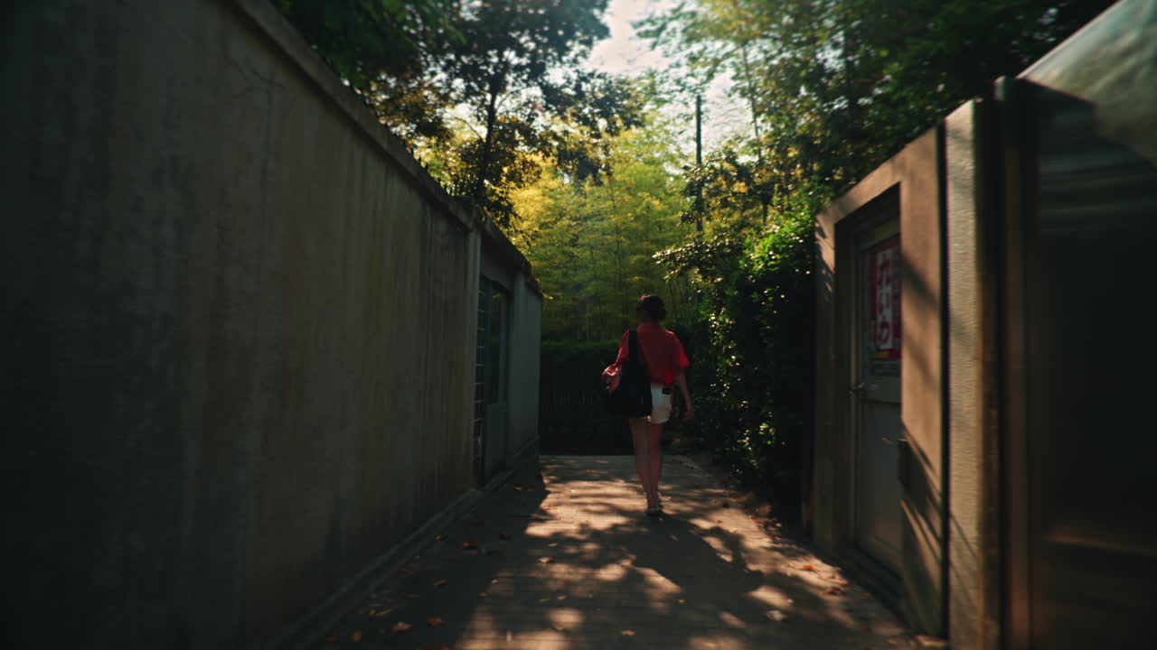 A woman walking down an alleyway