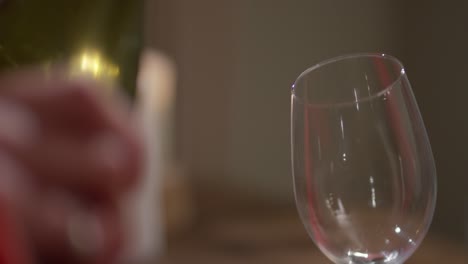 pouring red wine into glass