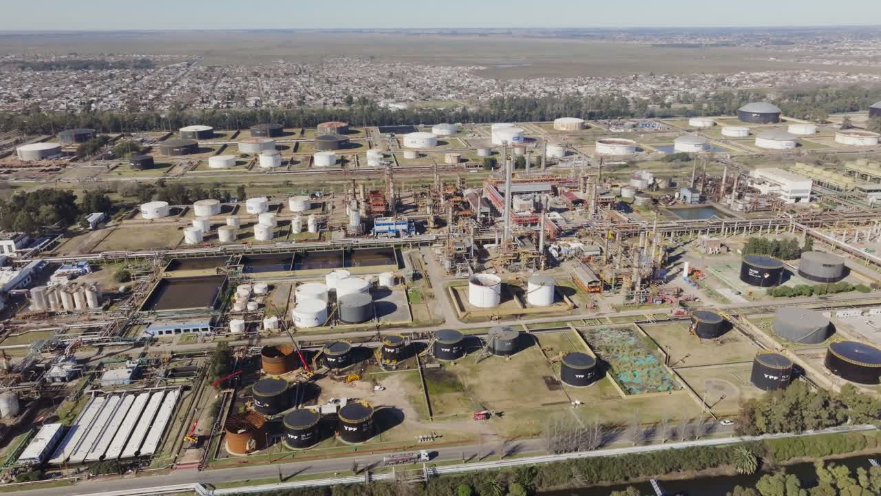 Drone footage of Argentine oil refinery with suburban area close by