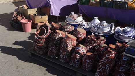 traditional pottery on display in a sunny tunisian market, rich with colors and textures