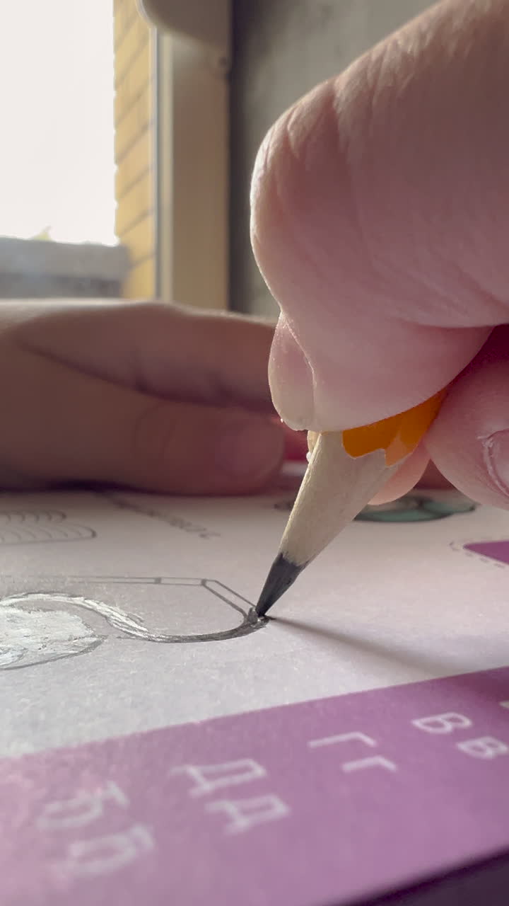 Close-up of a Person's Hand Sketching with a Pencil