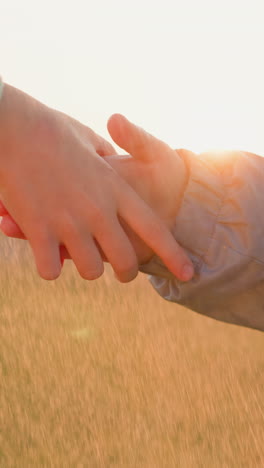 boy and girl hold hands under rainfall closeup. children spirits soar with hearts filled with joy of carefree innocence among meadow during sunset