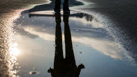 a reflective journey: a sole runner's footsteps through a puddle, capturing the tranquility of solitude and nature's beauty in urban settings