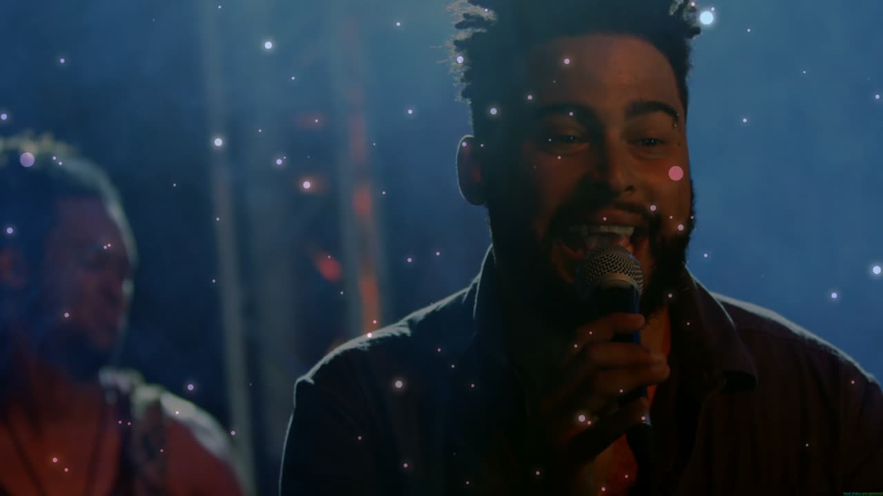 Singer holding microphone, guitarist strumming guitar under haze, truss lights boosting music ads