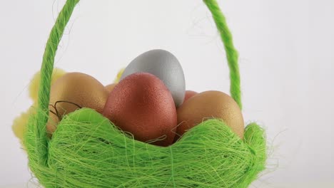 colorful easter eggs in a green basket