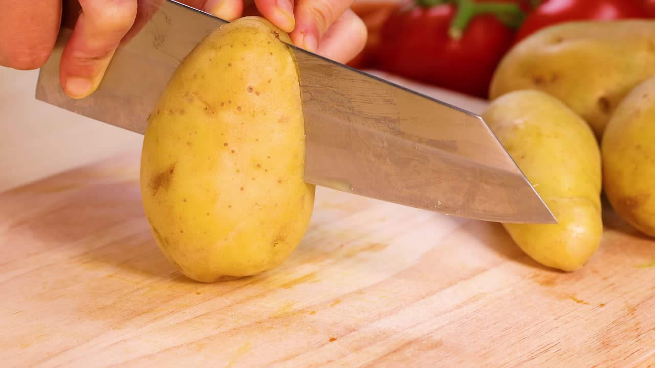 Slicing potatoes into wedges with a knife