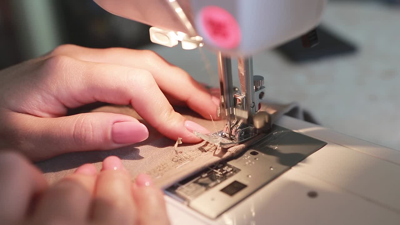 Concept of Tailoring and Making Clothes. Woman sewing clothes in the kitchen at home