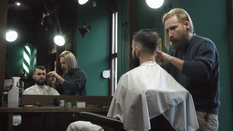 barber cutting client's hair in a barbershop