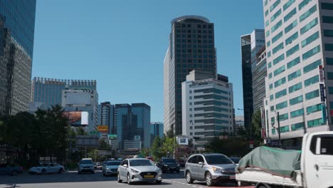 vehicles driving in daylight at sejong-daero street near seoul city hall in south korea