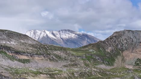 daytime-mountain-landscape-dynamic-slow-stable-wide-aerial-drone-shot-in-alpine-environment-and-moody-cloudy-sky