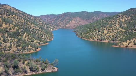 drone ascends in recreational area with lake