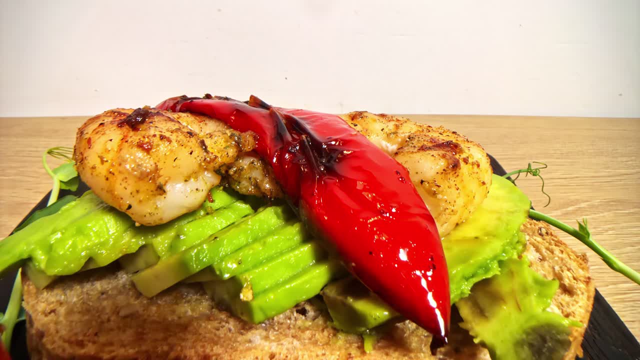 Avocado toast with grilled shrimp and roasted red peppers open-faced sandwich crostini